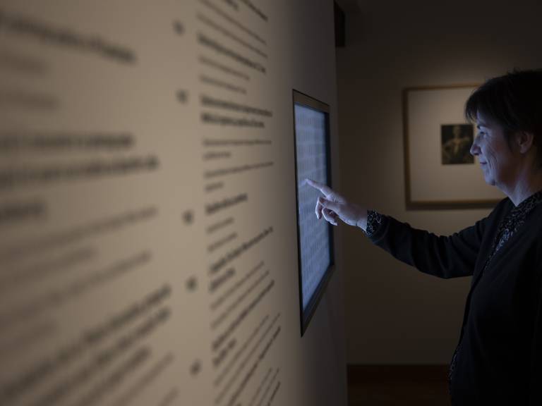 Visitor consulting the digital panel in the Steichen cabinet